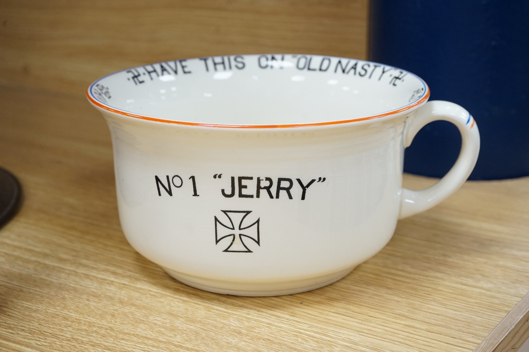 A WWII Fieldings Crown Devon novelty musical chamber pot, decorated with; No. 1 “Jerry”, Have This On Old Nasty, Another Violation of Poland and cartoon image of Adolf Hitler. Diameter 21.5cm, height 12cm